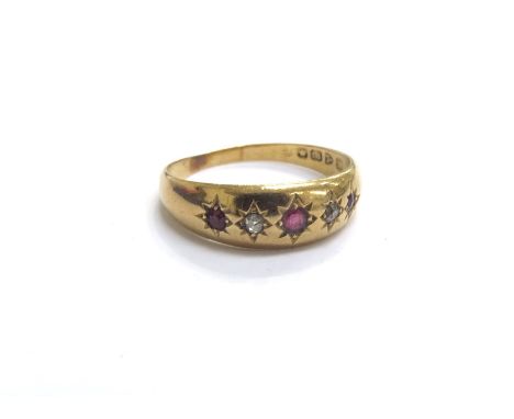 An 18ct gold five stone diamond and ruby gypsy style ring. Size R, 1.9g 