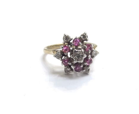 A 9ct gold ruby and diamond cluster ring. Size N/O, 3.1g 