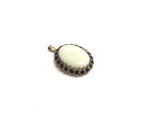 A 9ct gold framed pendant, the oval opal 25mm x 18mm framed by sapphires, 8.7g 