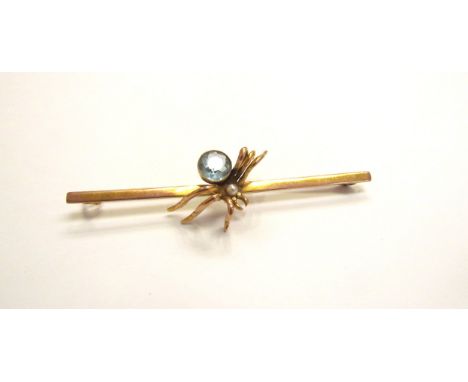 A gold bar brooch with a spider to centre, having a pearl head and aquamarine body, stamped 9ct, 7.8cm long, 7.2g 