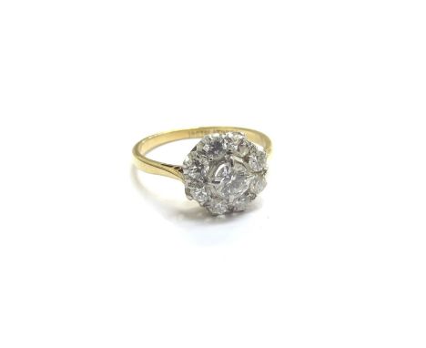 An 18ct gold platinum set diamond daisy ring, 10mm diameter. Size M, 2.4g 