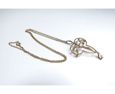 An Edwardian seed pearl and aquamarine drop pendant/brooch (brooch fitting a/f pin missing) stamped 9c hung on a gold chain s