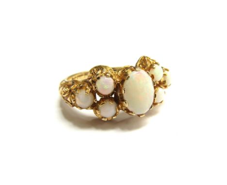 A 9ct gold ring set with seven opals. Size M, 3.7g 