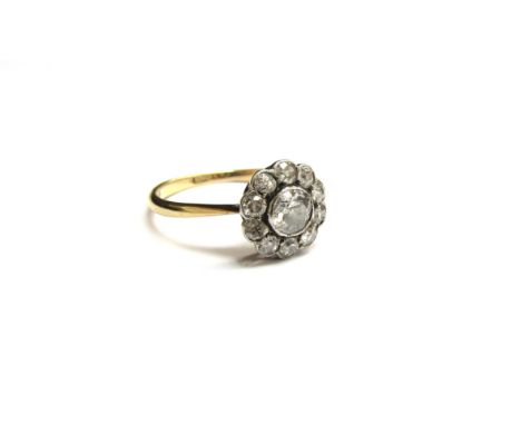A diamond daisy ring, 10mm diameter, marks rubbed. Size K, 2g 