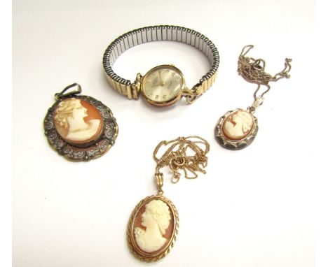 A gold chain stamped 9k hung with a cameo pendant, a silver example, filigree cameo pendant and a Rotary wristwatch 