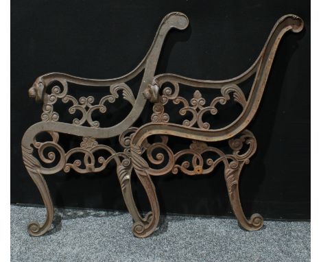 A pair of cast iron garden bench ends, cast with lion masks 