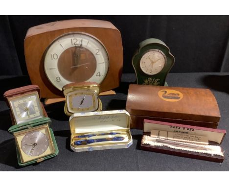 A mid 20th century mantel clock; a Conway Stewart fountain pen and pencil set; a Swiss tin cartouche shaped clock;  travellin