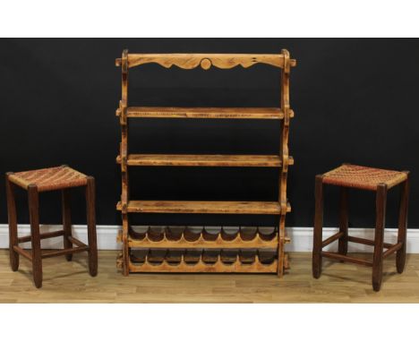 A pine kitchen shelf with wine rack, 102cm high, 79cm wide, 16.5cm deep; two rope seat stools, 47cm high, 30.5cm square (3) 