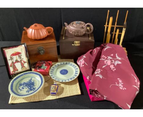 A terracotta Yixing teapot, frog finial, 17cm wide, boxed; another, pumpkin shaped, boxed; two celadon crackle glazed plates,