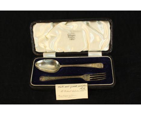 Silver spoon and fork in case made by W. F. Ranger, London. With note addressed to owner and their initials on the handle. Th