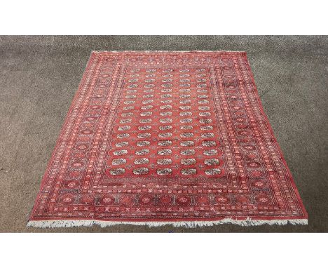 A red ground Persian carpet with all over geometric patterns.H.283 x W.310 cm. 