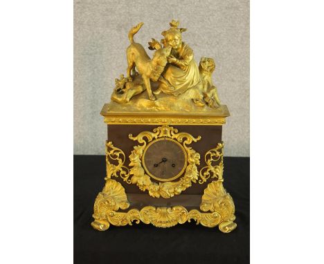 A 19th century French marble and ormolu mounted mantle clock surmounted with a young child and animals, the dial with etched 