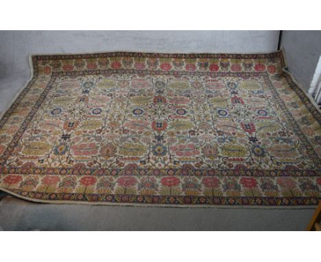 A large beige ground Persian carpet with all over stylistic floral design. W.220 L.327cm 