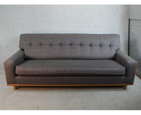 A 20th century G-Plan teak framed grey button back upholstered settee raised on tapering supports. H.95 W.215 D.100cm 