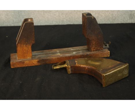 A 19th century mahogany table top hat stretcher, together with a 19th century brass and mahogany powder flask. L.30cm. (large