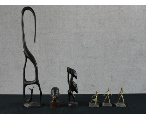 A set of three contemporary African brass figures raised on hardstone bases, together with a contemporary hardwood figural, a