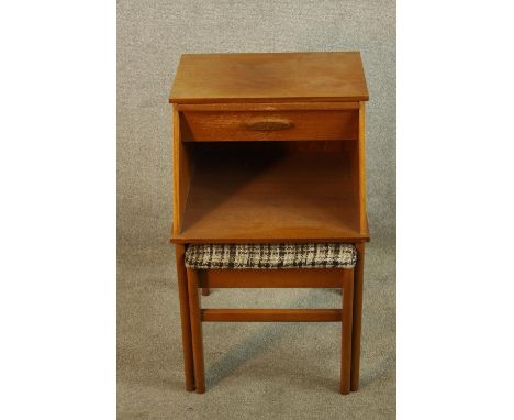 A mid 20th century teak telephone table with integral sliding seat, raised on square supports. H.69 W.43 D.75cm. (extended). 