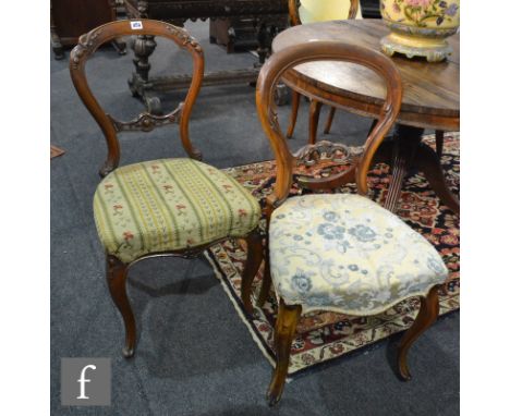 A pair of Victorian carved walnut salon chairs with pierced splats on cabriole legs and tapestry seats, together with another