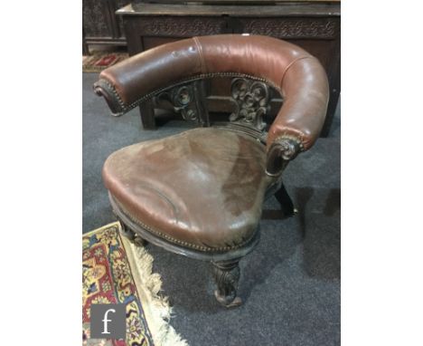 A 19th Century mahogany library elbow chair, with a crescent shaped back rail over carved scroll splats and a cartouche shape