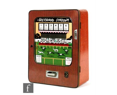 A 1970s wall mounted Greyhound Stadium penny slot machine, height 68cm, with key. 