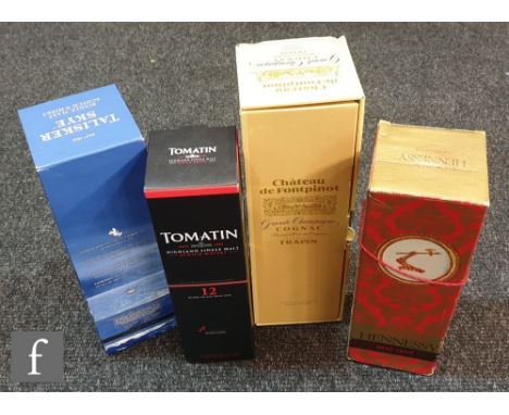 A bottle of Talisker Skye single malt scotch whisky, a bottle of Tumatin single malt, a bottle of Grande Champagne Chateau de