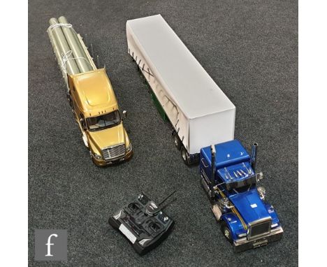 Two 1:14 scale remote control models, the first composed of a Tamiya 56340 Freightliner Cascadia Evolution tractor unit with 