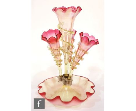 A late 19th Century epergne, the petal edged bowl rising to a central flute flanked by three lower trumpets, each in graduate