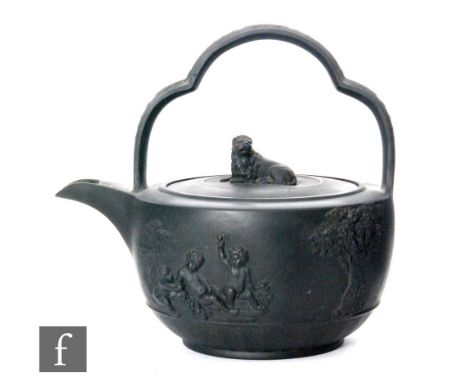 A 19th Century Wedgwood black basalt tea kettle decorated with applied scenes of cherubs playing and large leafy trees, the l