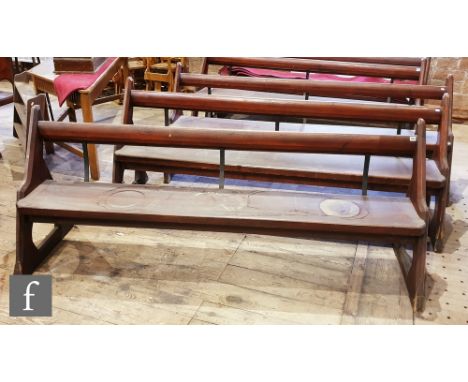Three pine pews with iron supports on shaped ends, one lacking its prayer book shelf, height 88cm x depth 67cm x length 225cm