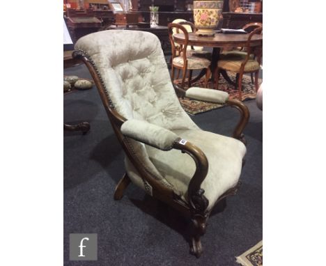 A Victorian walnut framed open armchair with acanthus carved capitals over a serpentine fronted seat rail and scroll feet, la