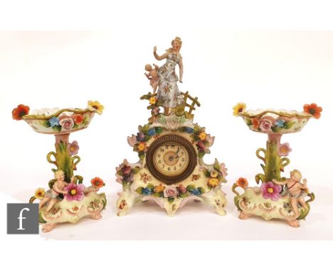 A late 19th Century continental hard paste porcelain clock garniture decorated with a female figure, putti and flowers picked