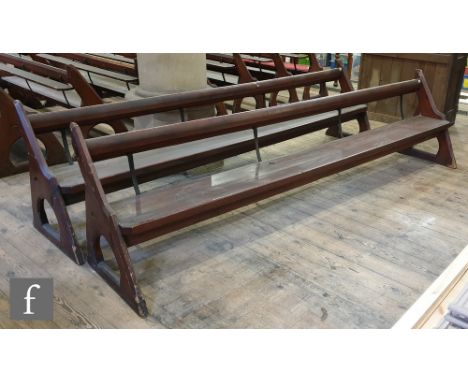 A long pine pew with iron bar support and prayeror hymn book shelf, shaped open ends, height 88cm x depth 66cm x length 333cm
