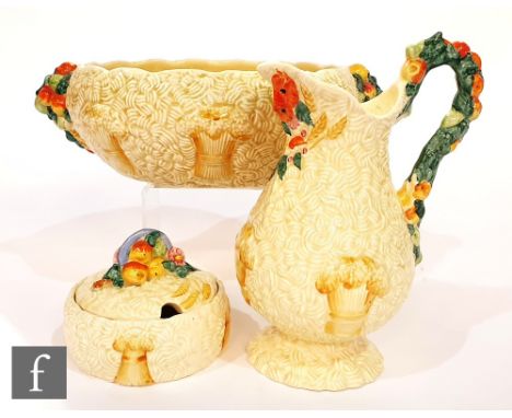 A twin handled Clarice Cliff, Newport Pottery Celtic Harvest fruit bowl, printed mark, length 29cm, together with a matching 