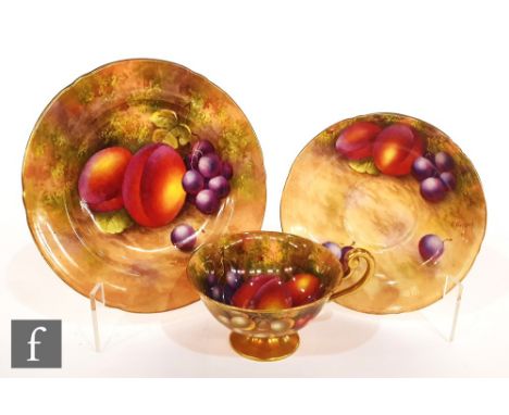 A Royal Worcester Fallen Fruits trio decorated by Ayrton and Townsend, the cup interior and saucer with hand painted peaches 