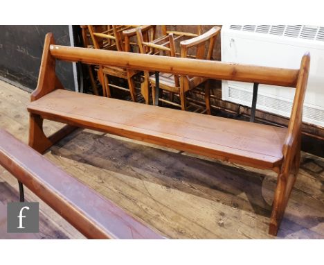 A light pine pew with iron bar and prayer book shelf, height 88cm x depth 66cm x length 198cm. 