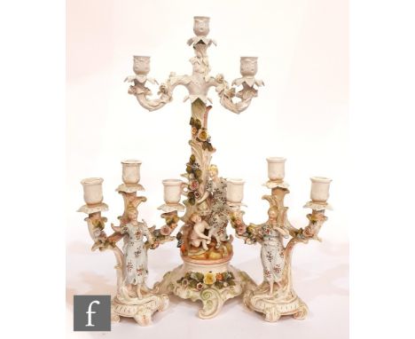 A late 19th Century continental hard paste porcelain candelabra with a four light sconce above a figural decorated column and