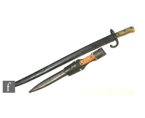 A 19th Century French brass hilted bayonet and scabbard and a Second World War bayonet and scabbard. (2) 