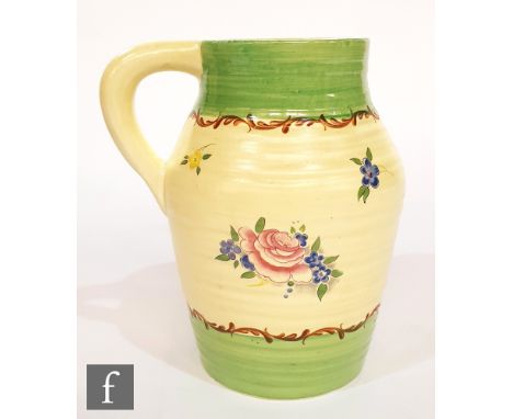 A Clarice Cliff Lotus shape jug decorated in the Pompadour pattern decorated with floral sprays on the cream ground between g