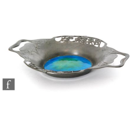 A Liberty &amp; Co. Tudric pewter and enamel two handled dish, the sides pierced and embossed with clovers, sinuous stem hand