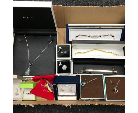 A box filled with boxed costume jewellery. 