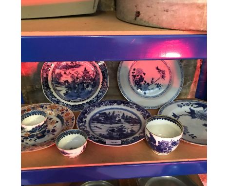 A shelf of oriental blue &amp; white plates &amp; bowls 