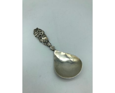 A Chester silver caddy spoon, Makers Shipton &amp; co Ltd, Dated 1922. Designed with a grape/ vine leaf stem handle. 