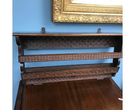 An Arts &amp; Crafts hand carved wall shelf. Measures 33x67x14cm 