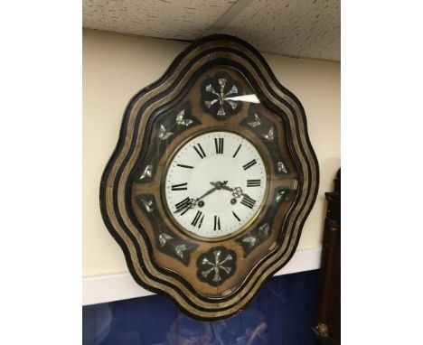 A Victorian wall clock. Designed with mother of pearl inlay. Measures 61x49x14cm 