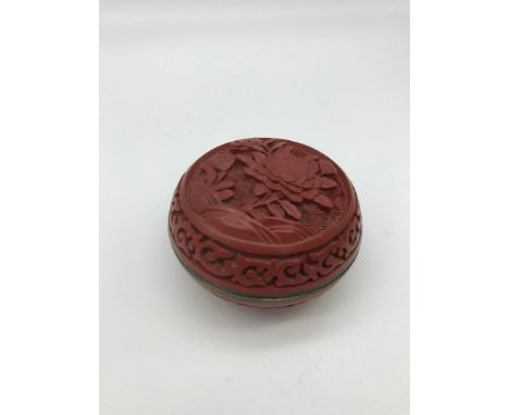 A Chinese red Sinnabar lacquered trinket box styled with green cloisonne to the interior (4x6.5cm) 