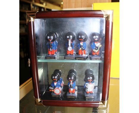 GLAZED CERAMIC GOLLIES. Seven Robertsons Golly figures in display box