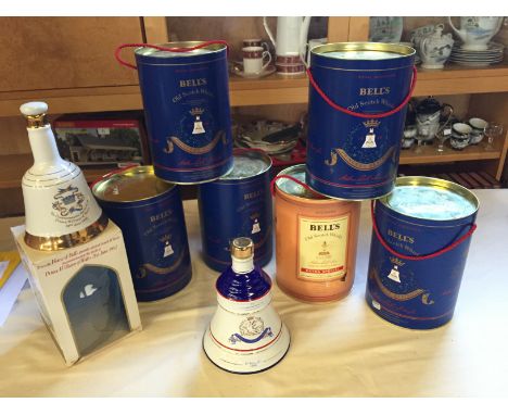 A selection of commemorative Bells whisky in Wade decanters Three Beatrice decanters full.