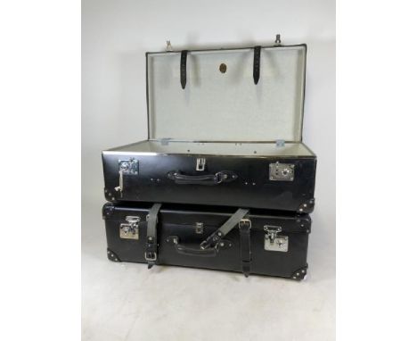 A pair of Globe Trotter large leather suitcase with leather straps, wheels and stamped locking mechanism. RRP Ã‚Å3600. W:82cm