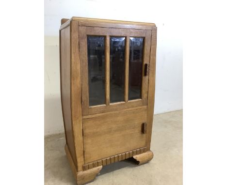An Art Deco 1930s light oak cupboard with bevelled glass and ballooned sides W:46cm x D:30cm x H:86cm