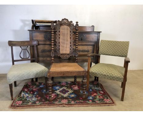 A bobbin turned oak chair with carved back and cane seat W:49cm x D:44cm x H:108cm. With two other chairs, a foot stool, a ru